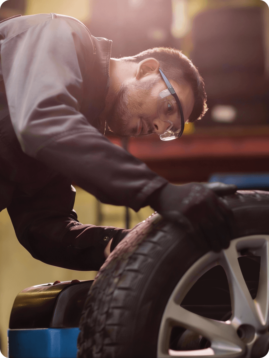 Mechanic inspecting tire and wheel