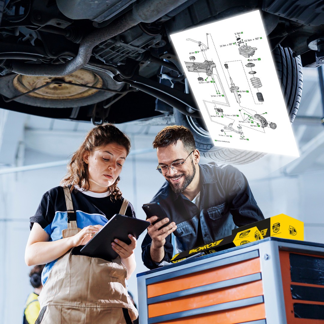 QR Code Technical Drawing Monroe Two installers looking at the Monroe suspension technical drawing in a garage