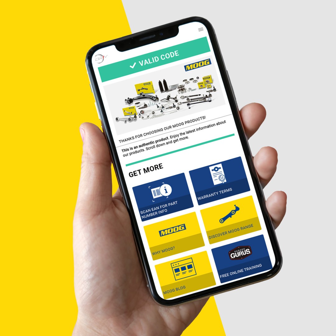 moog_qr_code_blog_banner-1 Two automotive mechanics in a workshop examining detailed Monroe technical drawings accessed by scanning a Monroe QR code on the product packaging.