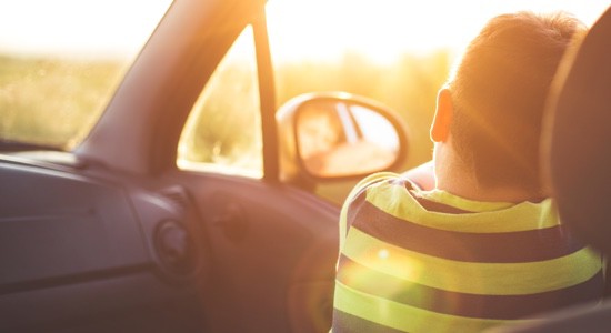 Child-Hanging-Out-Car-Window