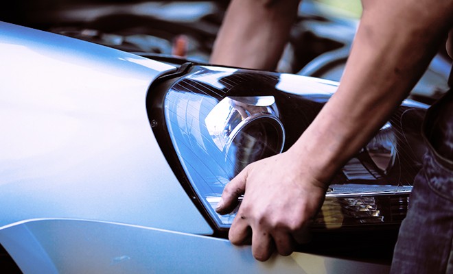 mechanic-removing-car-headlight-lens mechanic-removing-car-headlight-lens
