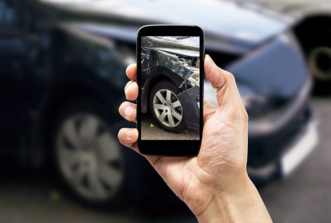 person-taking-picture-of-car-crash
