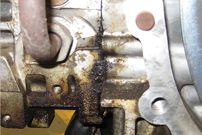 subaru-failed-head-gasket Close up view of external oil leak due to a failed gasket