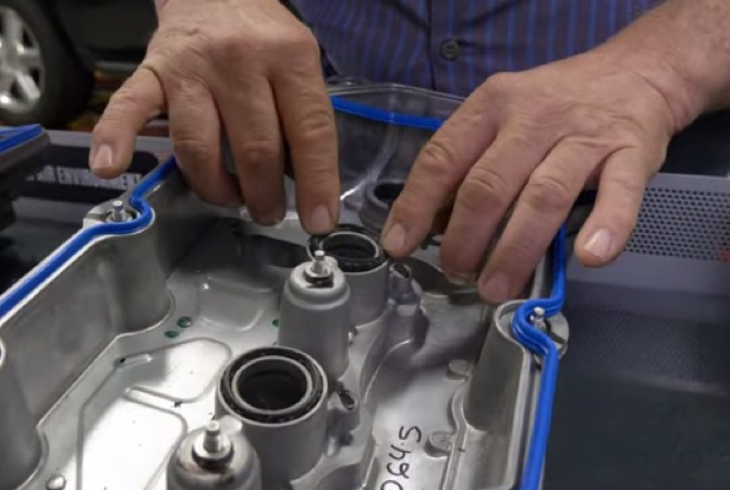 pressing-spark-plug-tube-seals-in-place Pressing spark plug tube seals in place.