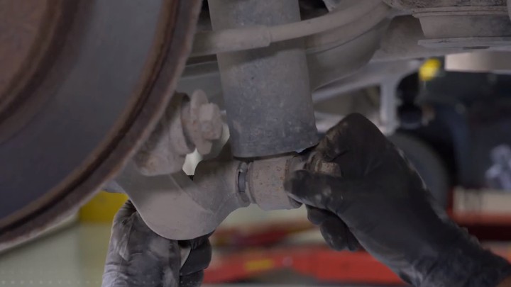 Removing shock lower mounting nut Removing shock lower mounting nut