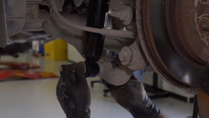 Installing lower mounting nut on shock Installing lower mounting nut on shock