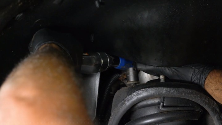 install-struts-chevy-silverado-gmc-sierra-1500-step-3 Technician removing the upper mounting nuts