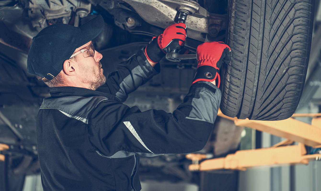 Mechanic-Working-On-Car-Suspension-System Mechanic-Working-On-Car-Suspension-System