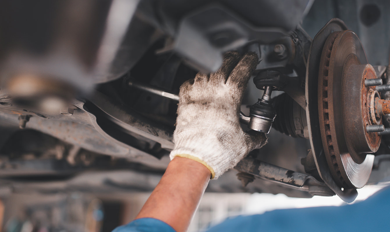 Auto-Technican-Working-On-Vehicle-Control-Arm Auto-Technican-Working-On-Vehicle-Control-Arm