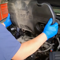 step-2-technician-removing-engine-cover step-2-technician-removing-engine-cover